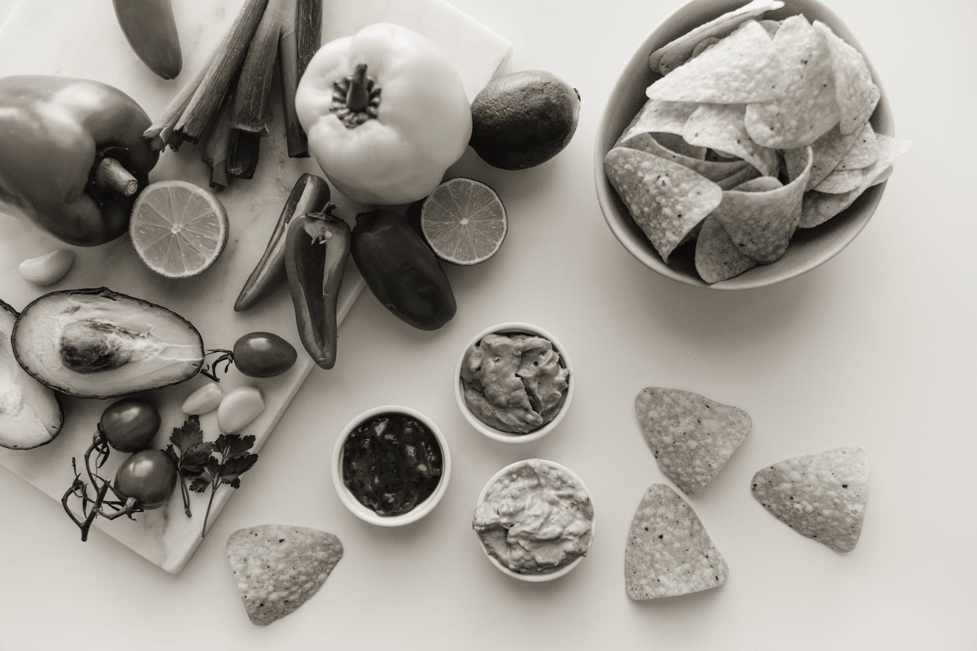 Tortilla chips beside a bowl of salsa set out for a party