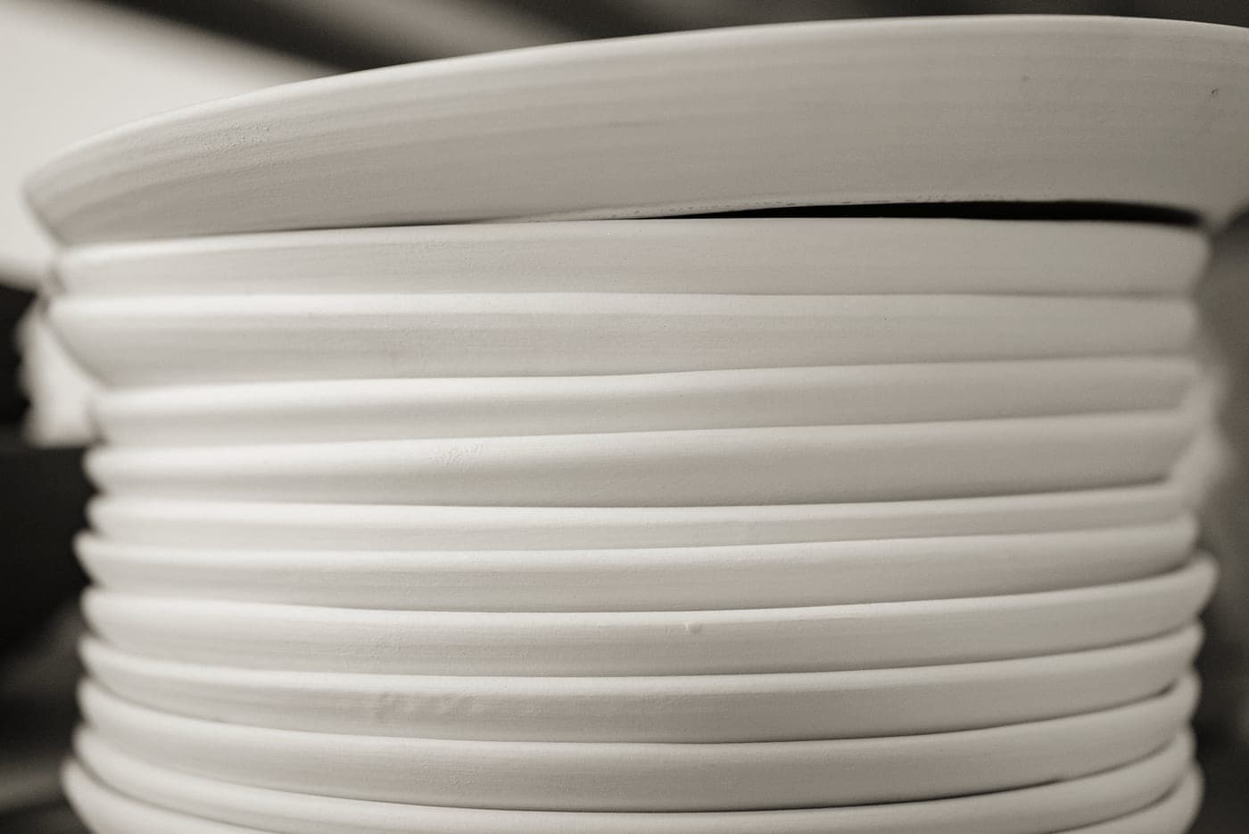 Clean white porcelain plates stacked square