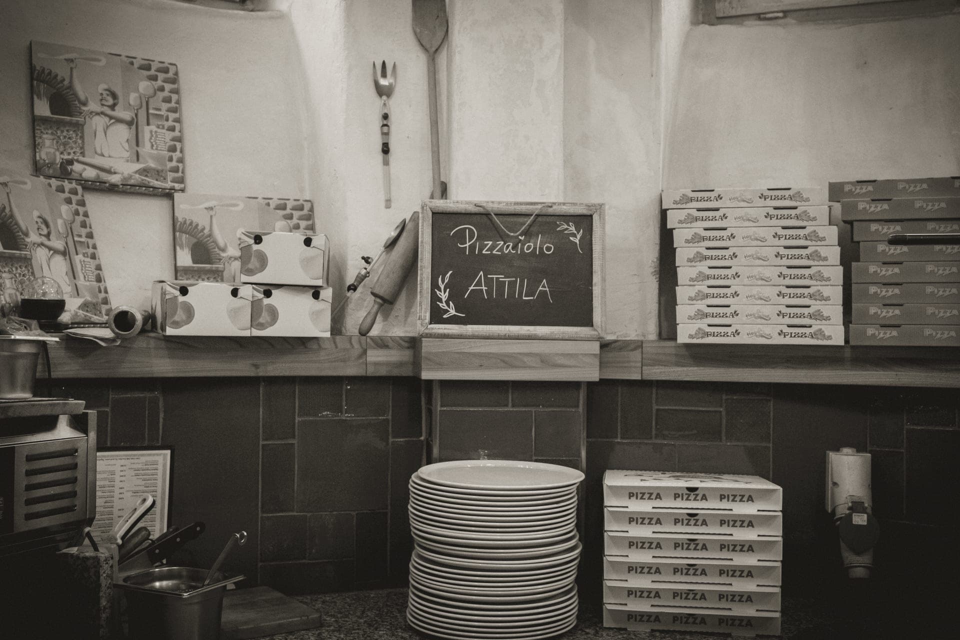 Several wooden serving boards stacked on a kitchen counter