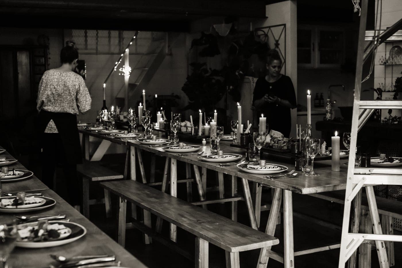 Hosts serving guests at a dinner party table