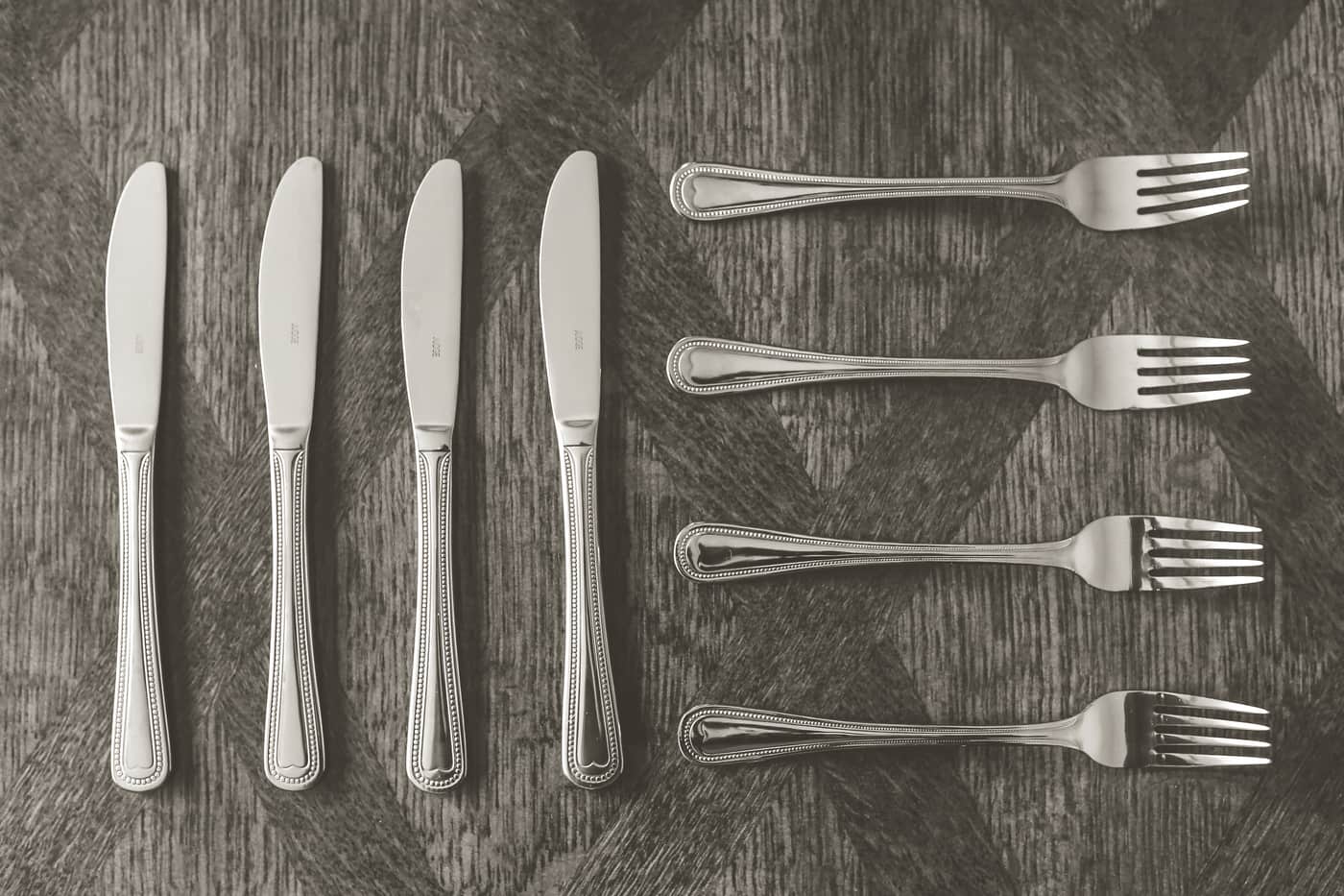 Forks and knives laid out on a linen cloth