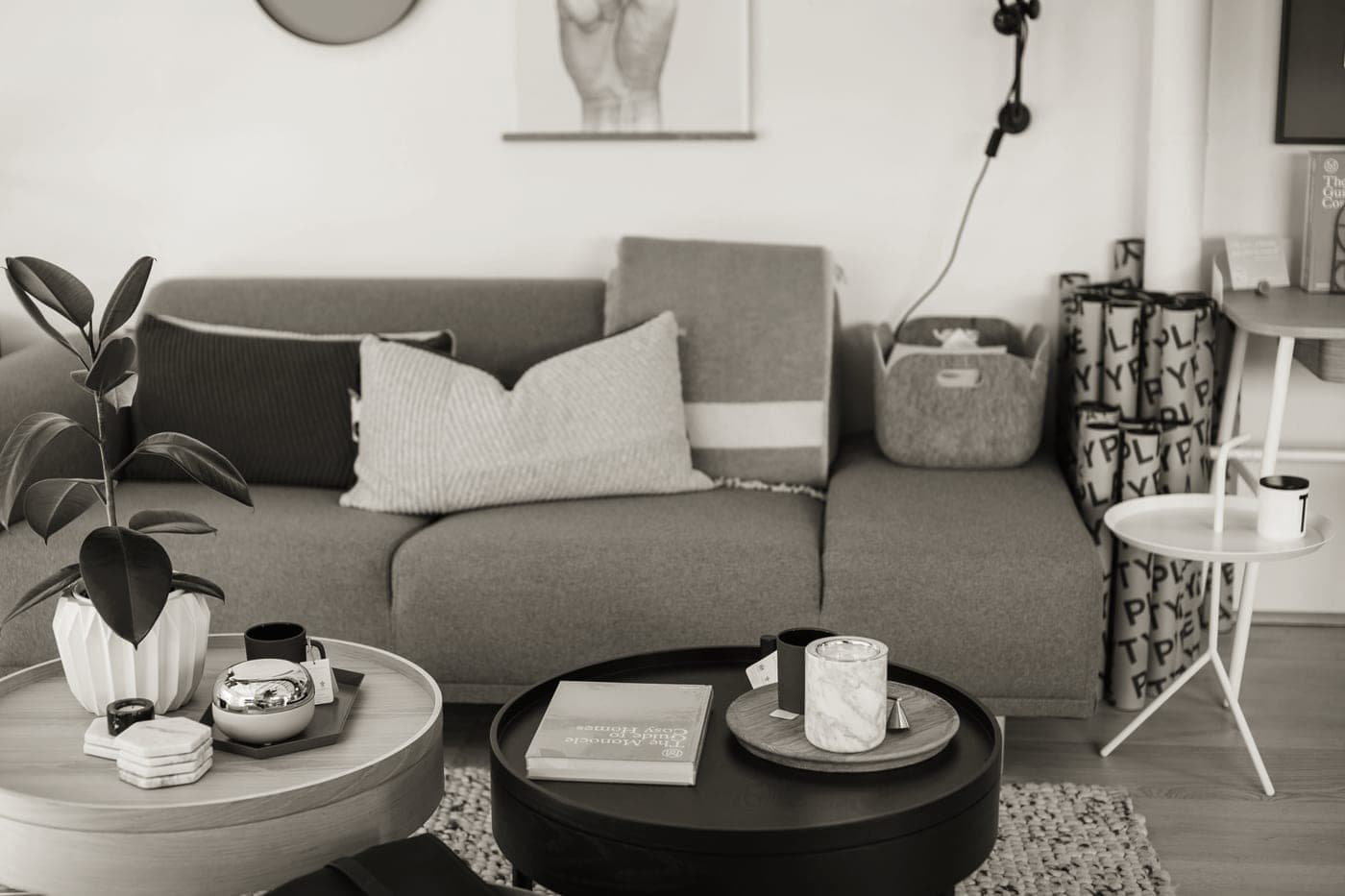 A styled tray sitting on a living-room ottoman beside a coffee table