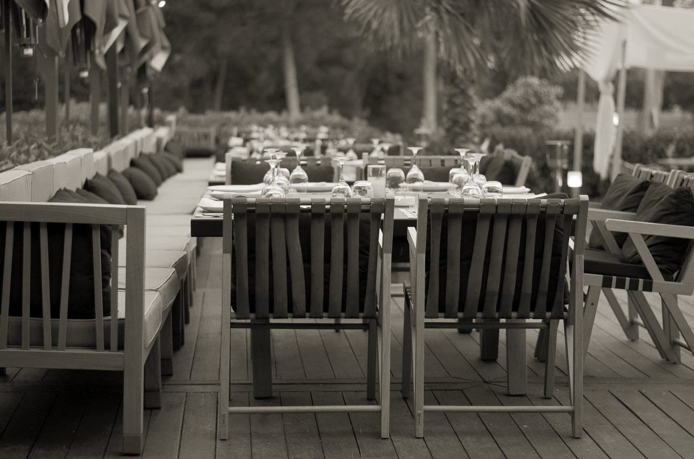 An outdoor patio table set for dinner on a summer evening