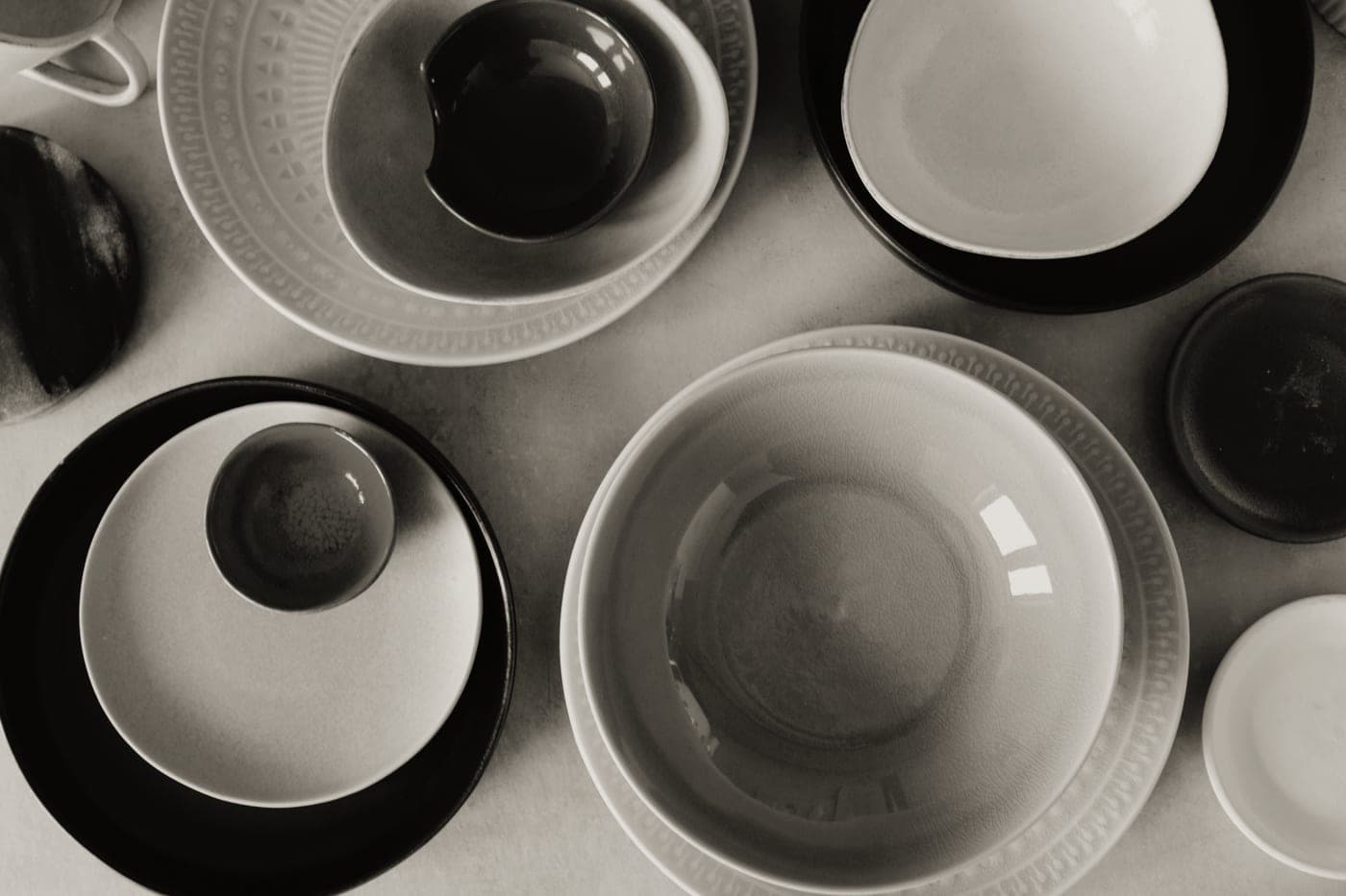 Ceramic serving bowls of salad set out on a table