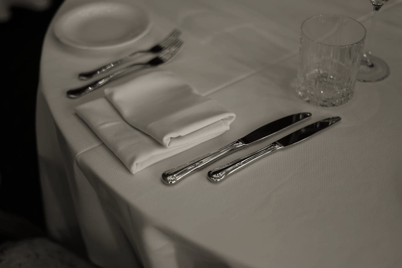 A formal place setting with fork, knife and folded napkin