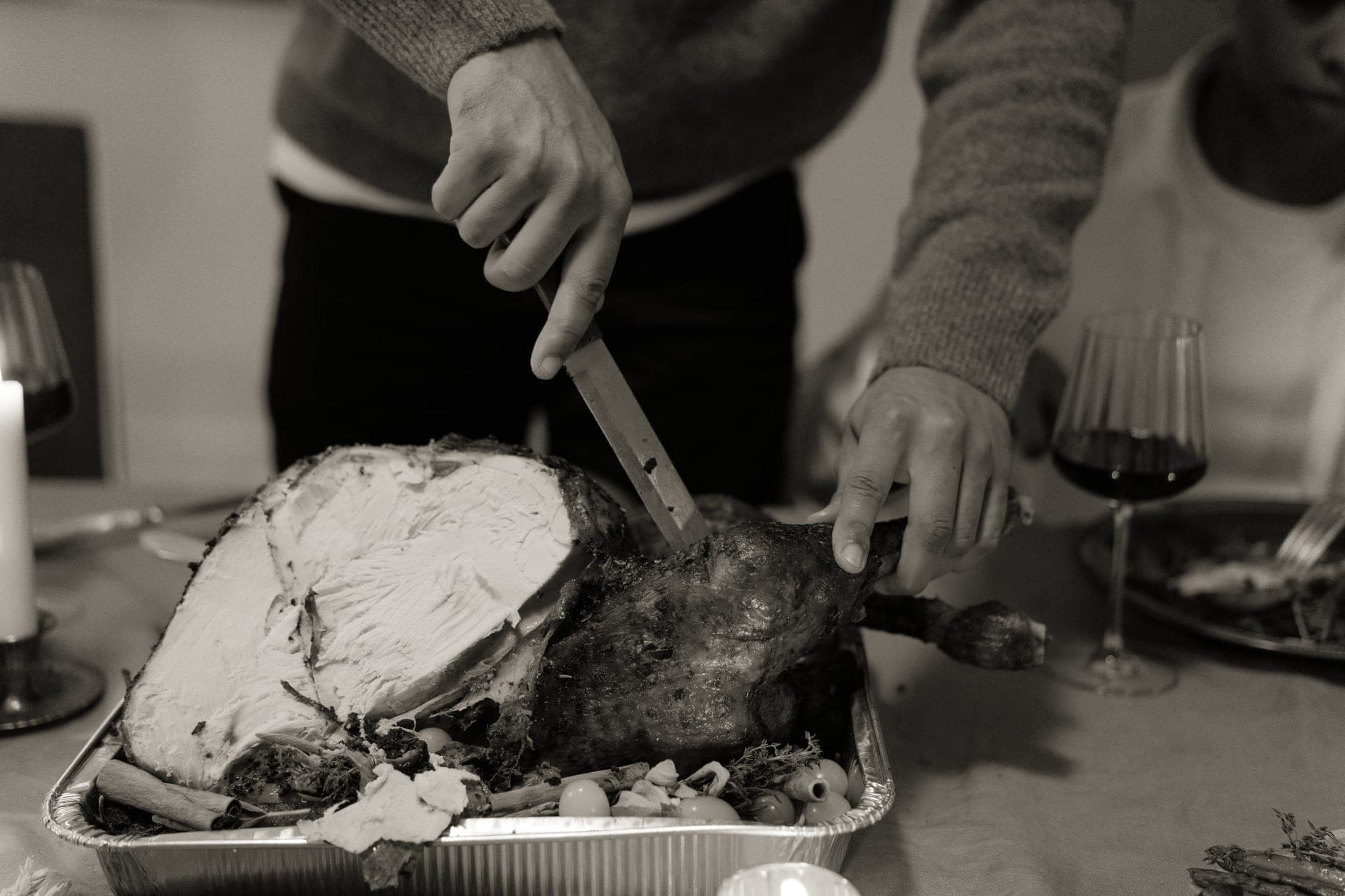 A roast turkey being carved at a holiday table