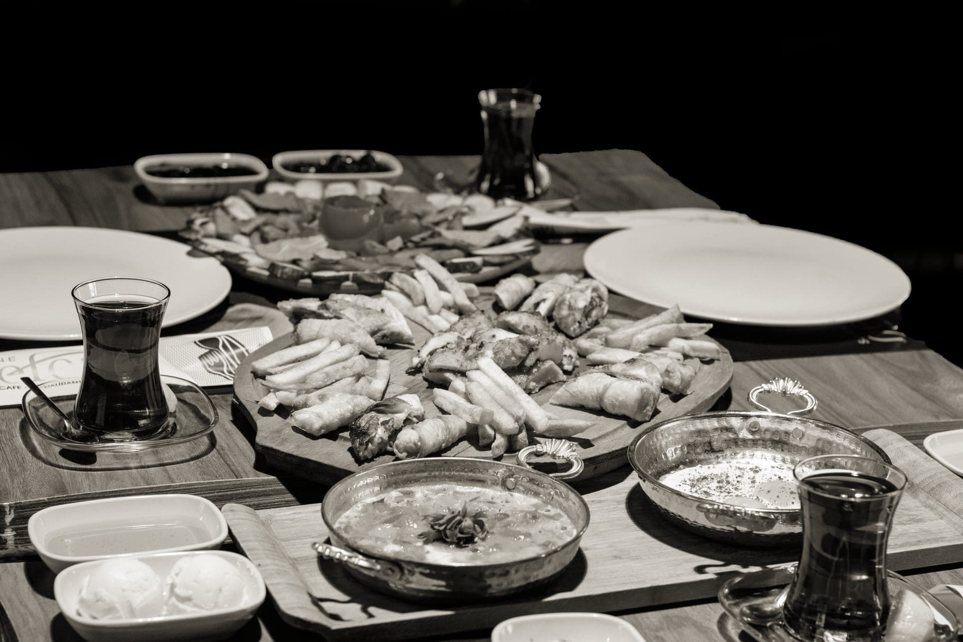 A large wooden serving tray holding food on a table